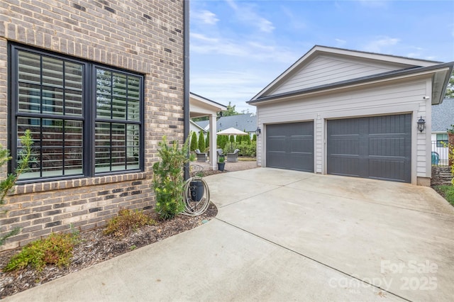 view of home's exterior featuring a garage, brick siding, and an outdoor structure