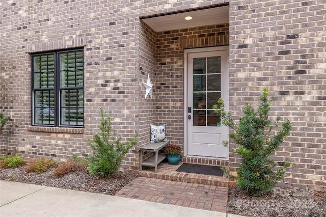 property entrance with brick siding