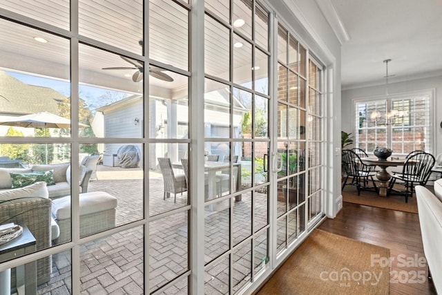 doorway to outside featuring ceiling fan with notable chandelier, recessed lighting, and wood finished floors