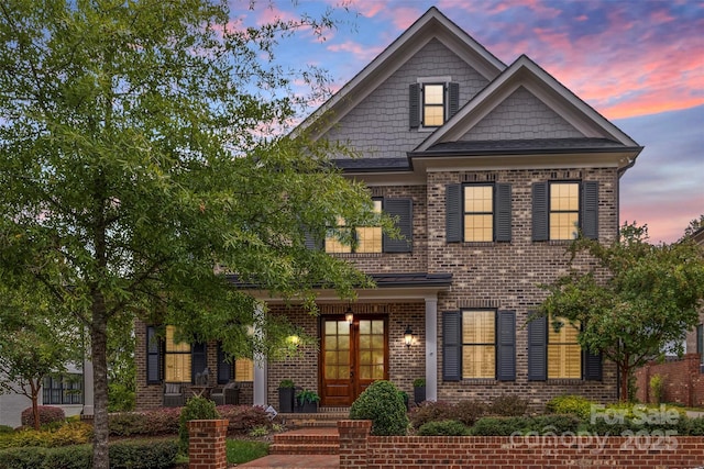 view of front of home featuring french doors and brick siding