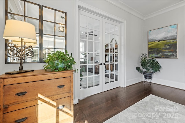 doorway with wood finished floors, a ceiling fan, baseboards, french doors, and ornamental molding