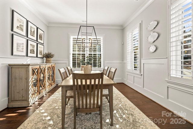 dining room featuring ornamental molding, dark wood finished floors, and a decorative wall