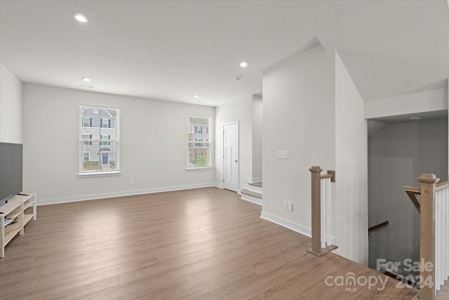 unfurnished living room featuring hardwood / wood-style floors and a wealth of natural light