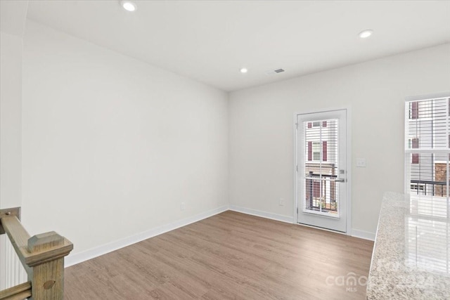 unfurnished room with light wood-type flooring