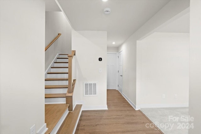 stairway featuring wood-type flooring