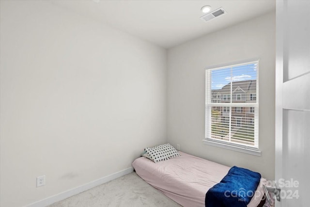 bedroom featuring light carpet