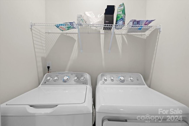 clothes washing area featuring washer and clothes dryer