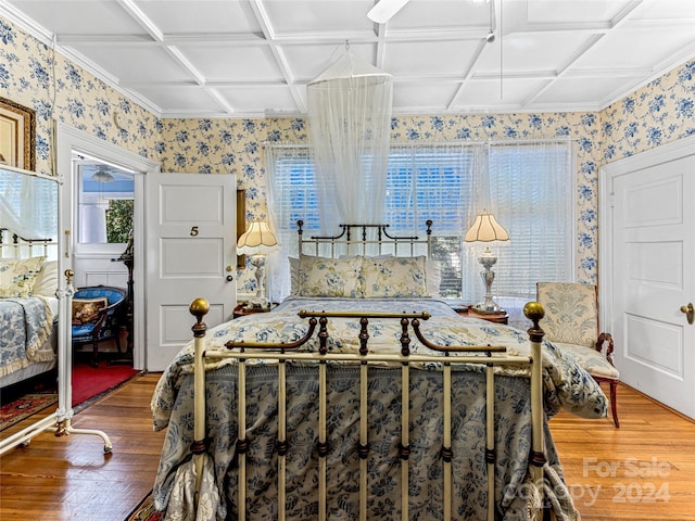 bedroom with hardwood / wood-style floors and coffered ceiling