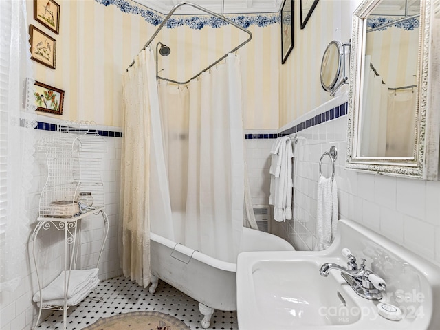 bathroom featuring tile patterned flooring, shower / bathtub combination with curtain, tile walls, and sink