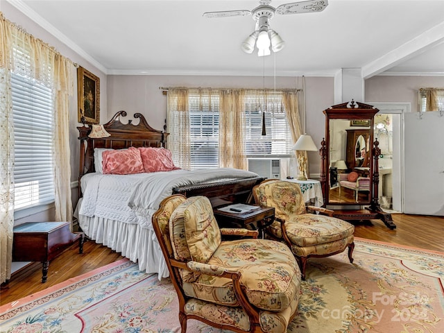 bedroom featuring multiple windows, ceiling fan, and hardwood / wood-style floors