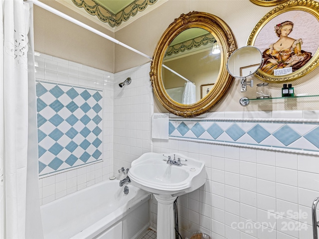 bathroom featuring shower / bathtub combination with curtain and tile walls