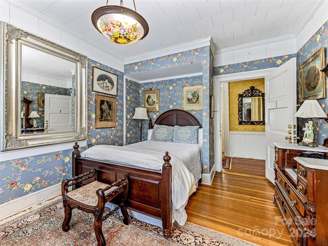 bedroom featuring hardwood / wood-style flooring and crown molding