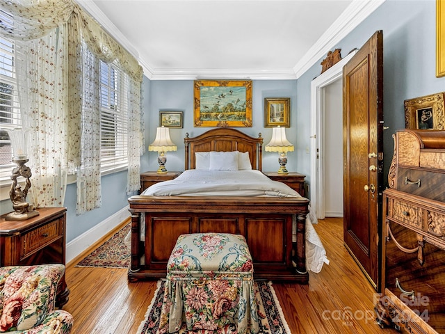 bedroom with light hardwood / wood-style floors and ornamental molding