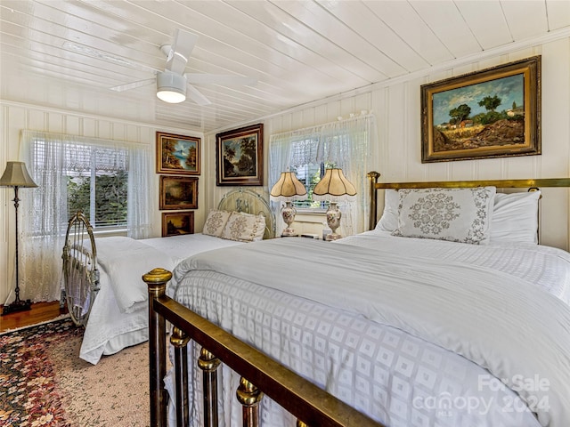 bedroom featuring carpet flooring, multiple windows, ceiling fan, and wooden ceiling