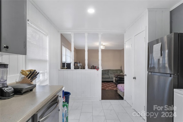 kitchen with stainless steel appliances and ornamental molding