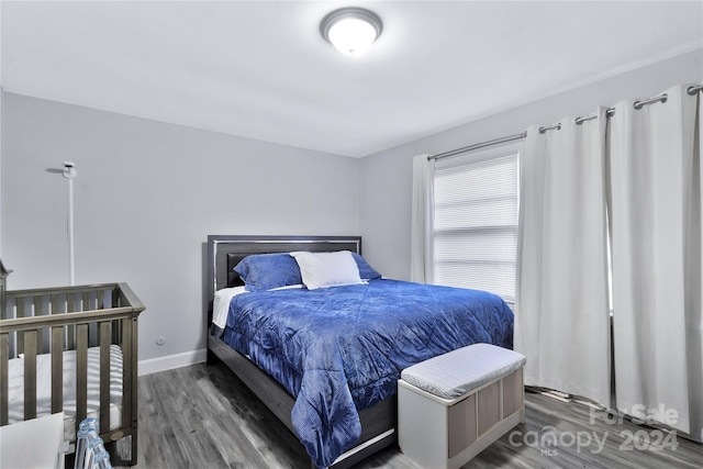 bedroom with dark wood-type flooring