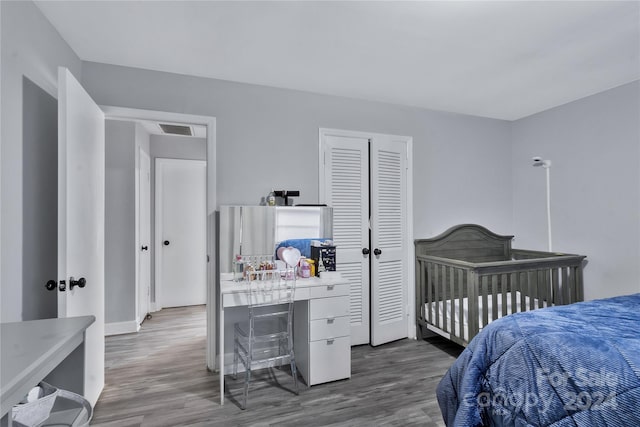 bedroom with hardwood / wood-style floors and a closet