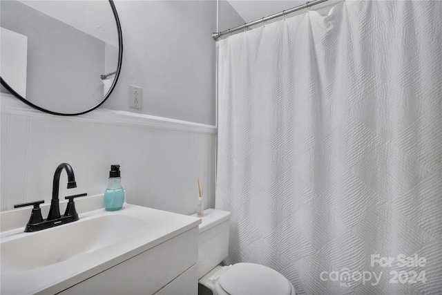 bathroom featuring vanity and toilet