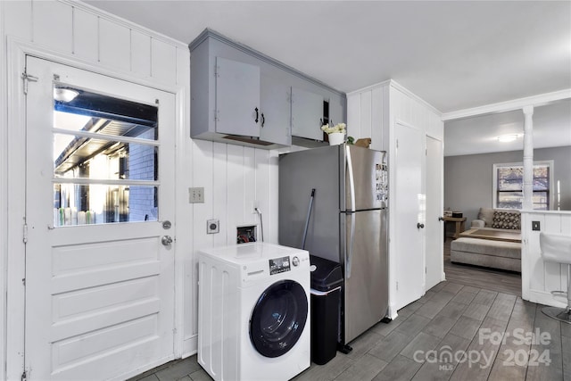 washroom with cabinets, dark wood-type flooring, and washer / clothes dryer