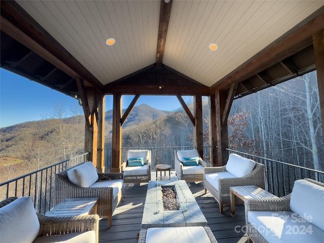 deck with a mountain view, a gazebo, and an outdoor living space