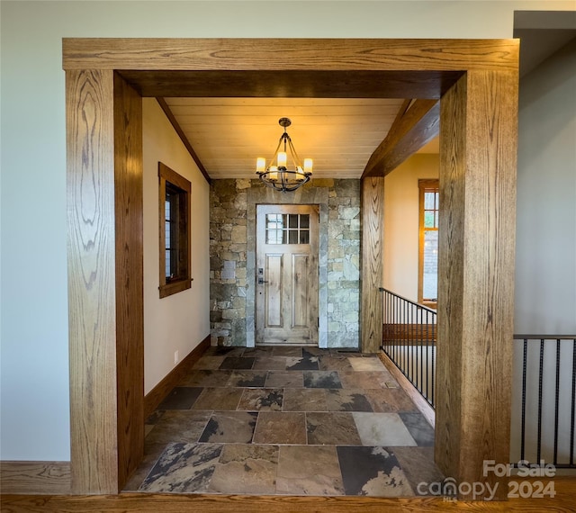 doorway featuring beam ceiling, a chandelier, and wood ceiling