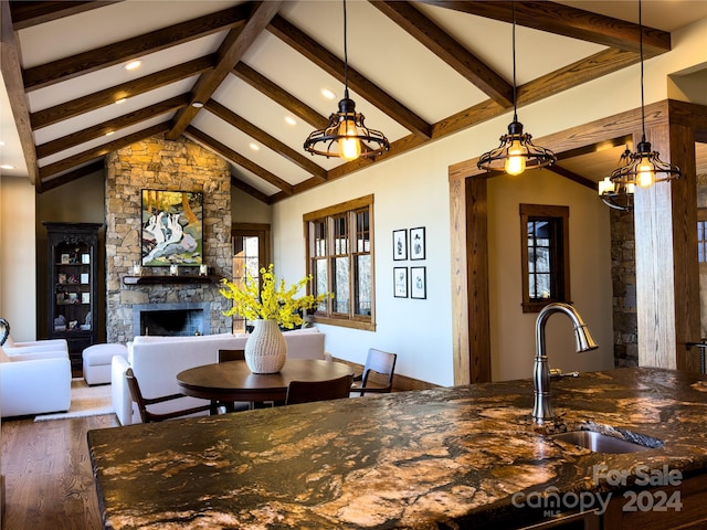 dining room with dark hardwood / wood-style floors, sink, plenty of natural light, and a fireplace