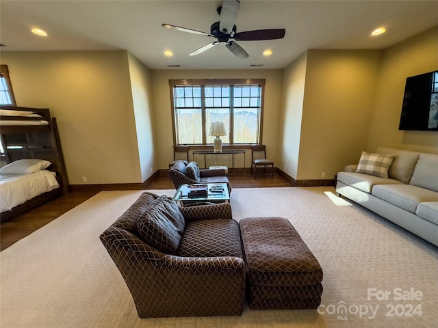 living room with hardwood / wood-style flooring and ceiling fan