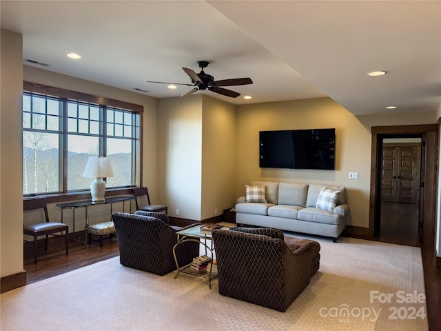 living room featuring ceiling fan and light hardwood / wood-style floors