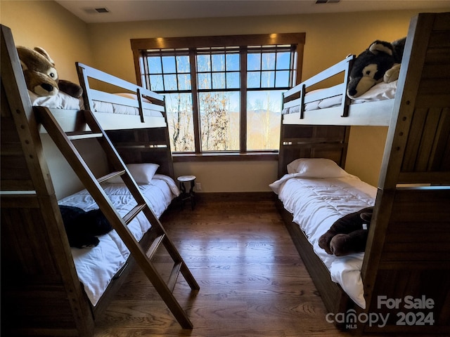 bedroom with dark hardwood / wood-style flooring