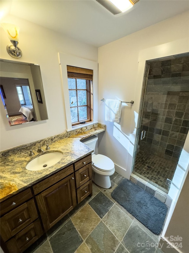 bathroom featuring vanity, toilet, and walk in shower