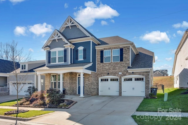 view of front of home featuring a garage and a front lawn