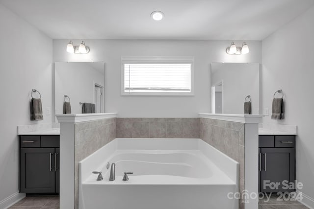 bathroom with vanity, tile patterned floors, and a bathtub