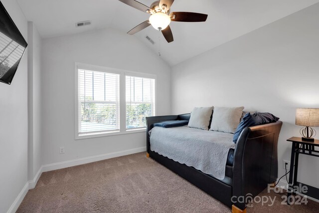 carpeted bedroom with vaulted ceiling and ceiling fan