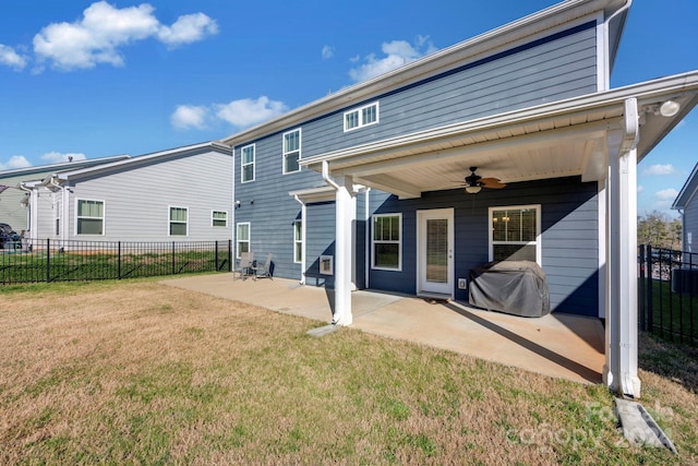 back of house with ceiling fan, a yard, and a patio