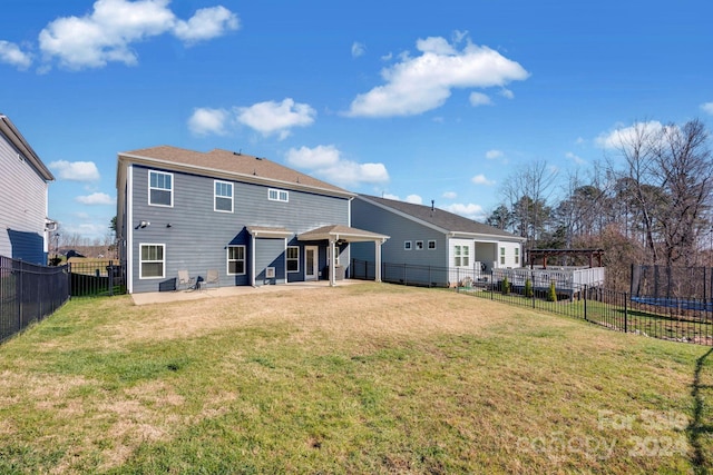 rear view of property featuring a patio area and a lawn