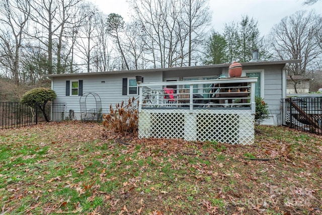 rear view of property with a wooden deck