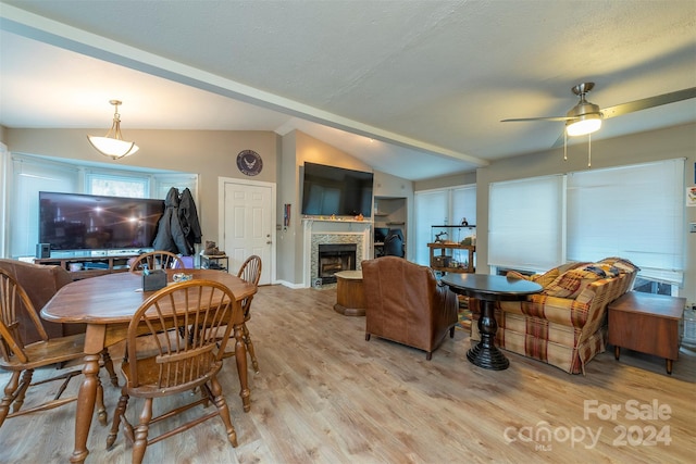 dining space with ceiling fan, light hardwood / wood-style floors, and lofted ceiling