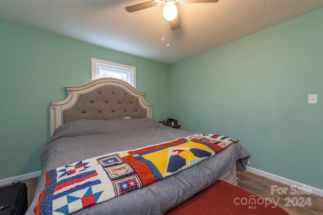 bedroom with hardwood / wood-style floors and ceiling fan