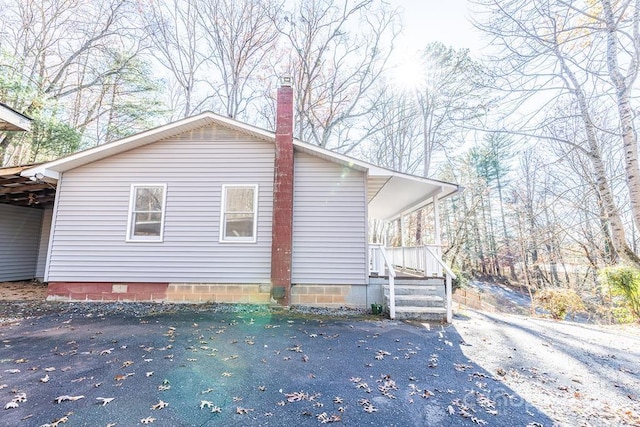 view of side of property featuring a carport