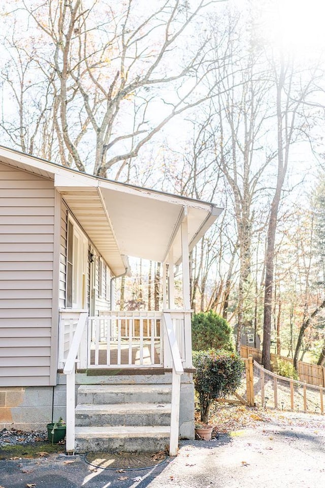 view of exterior entry with covered porch