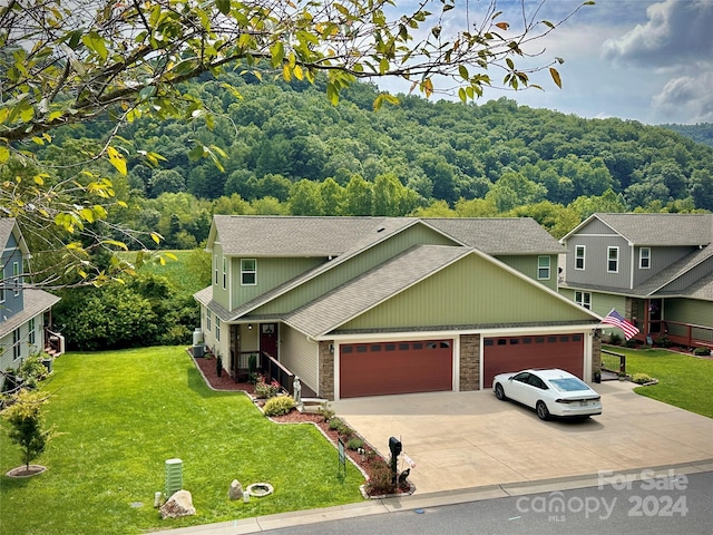 view of front of property featuring a garage and a front lawn