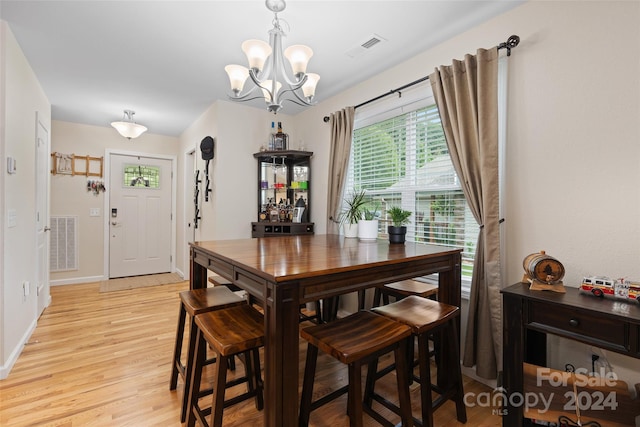 dining room with a chandelier and light hardwood / wood-style floors