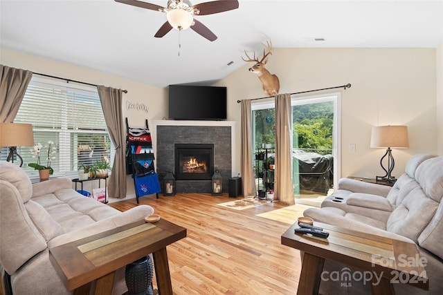 living room with hardwood / wood-style floors, ceiling fan, and vaulted ceiling