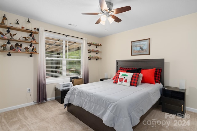 bedroom featuring light colored carpet and ceiling fan