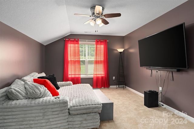 carpeted bedroom with a textured ceiling, ceiling fan, and lofted ceiling