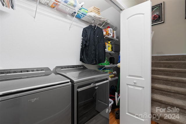 clothes washing area featuring separate washer and dryer and wood-type flooring