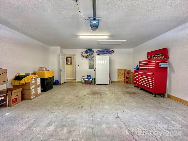 garage featuring electric panel, white fridge, and a garage door opener