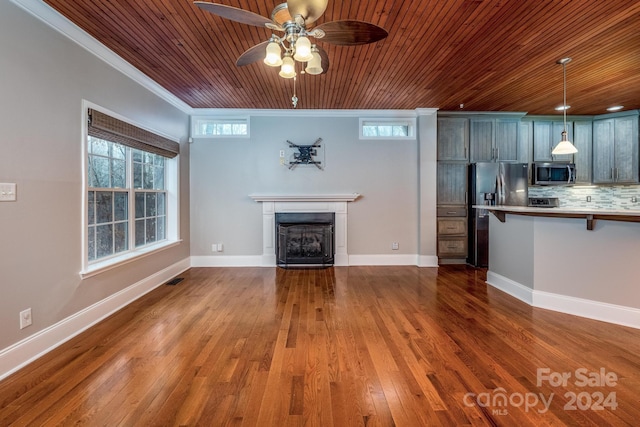 unfurnished living room featuring hardwood / wood-style flooring, ceiling fan, ornamental molding, and wood ceiling