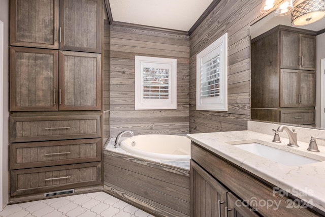 bathroom featuring vanity, a bathing tub, wooden walls, tile patterned flooring, and ornamental molding