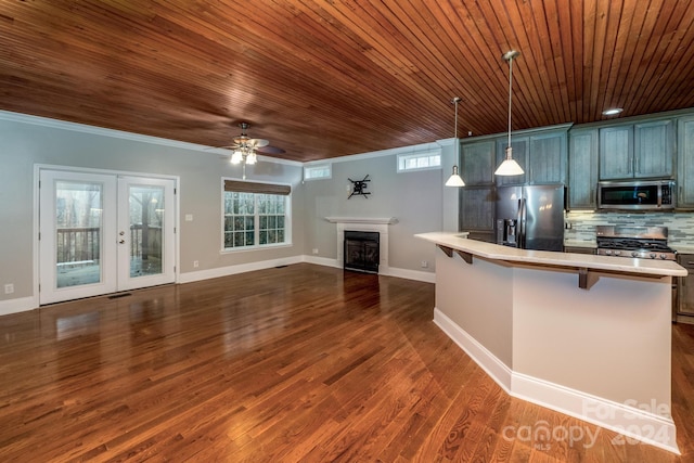 kitchen featuring pendant lighting, wooden ceiling, french doors, appliances with stainless steel finishes, and a breakfast bar area